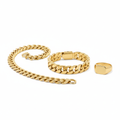 Gold Cuban link bracelet, chain necklace and signet ring on white background